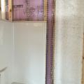 Moisture-resistant rigid foam insulation was installed to provide a continuous air and thermal barrier behind the tub-shower insert.  
