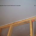The ceiling drywall is sealed to the top plates with caulk.
