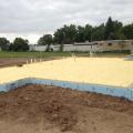 Rigid foam wraps the exterior of the foundation slab.