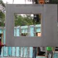 The home’s first-floor walls are constructed of insulated precast concrete panels that are set in place on a gravel bed. 