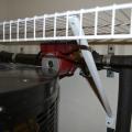 The hot water recirculation pump is hidden behind the water heater in a closet.