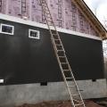 Extruded polystyrene (XPS) rigid foam is taped at the seams to provides a continuous air and weather-resistant barrier so no house wrap is needed; it also provides a continuous layer of insulation.