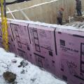 Right - The basement walls are wrapped with 3 inches of XPS rigid foam that will be taped at the seams then covered with a dimpled plastic water barrier.