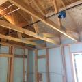 Rigid foam serves as the sheathing on these 2x6 24-inch on center walls; plywood is used only at the corners for wind bracing. 