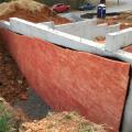 These below-grade walls are insulated along the exterior with R-5 of bug-resistant high-density rigid fiberglass insulation installed over damproofing. 