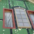 The rough openings for the windows are flashed with a paint-on flashing product then the windows are installed and additional flashing tape is installed over the flashing. Nail holes are sealed with caulk.