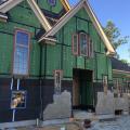 This home is covered with coated sheathing. Wall portions that will be covered with stone have a dimple plastic moisture barrier and metal lathe that is being covered with plaster.