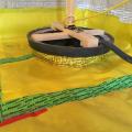 The sump pump is sealed to the subslab vapor barrier with sealing tape to prevent soil gas from leaking around the sump bucket.