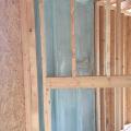 Spray foam insulates and air seals the exterior wall behind the fireplace.