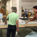 Right – Sheathing, rigid foam, and windows are installed in the factory for these factory-constructed wall panels.