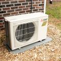 Right – The outside unit of the mini-split heat pump system is installed on a concrete pad and away from shrubs.