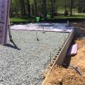 Right – The raised slab foundation has a 3-ft stem wall of filled concrete block, then is back-filled with compacted dirt and crushed rock, then insulated with 1” rigid foam covered with taped vapor barrier, under a floor slab.
