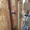 Right – Tape and spray foam are used to air seal around pipes that extend through exterior walls.