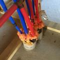 Right – Spray foam is used to seal around PEX plumbing pipes.
