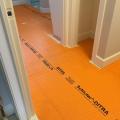 Right – A bond break layer is installed over the slab and under the floor tile.