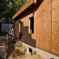  Taped plywood provides an air barrier beneath the cork insulation installed on the exterior of this home.  