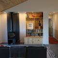 Right - The high-efficiency wood stove is located on an interior wall in this home to provide a secondary heating source in cold climates.