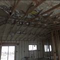 Right – Spray foam insulation is sprayed on the underside of the roof deck to provide a conditioned space in this low attic for the HVAC ducts.