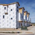 Right - House wrap is carefully installed from the top of the roof line to the foundation; seams are overlapped and taped to provide a continuous air- and weather-resistant barrier