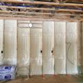 Right – the 2x6 walls are insulated with a flash-and-batt approach that includes spraying the wall cavities with one inch of open-cell foam to seal the sheathing to the framing then filling the wall cavities with R-19 fiberglass batts that are compressed slightly to fill the cavities.