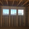 Right – The window header is filled with spray foam and sealant is used to air seal wood-to-wood seams; however, it would be preferable to design the wall to avoid so many stacked studs around the windows because they prevent the installation of wall insulation and lead to cold spots.
