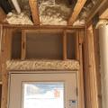 Right – Spray foam insulation fills the header above the door and fills the rim joist between floors.