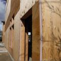 Right – A 1-inch layer of XPS rigid foam covers the 2x6 wall studs and is topped by ½-inch-thick plywood sheathing, which is covered with draining house wrap and serves as a nailing surface for siding and trim.