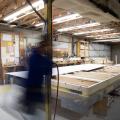 Right – Subfloors are installed in a clean, dry, well-lit factory setting for these modular, factory-built homes.