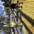 Right – Workers lay radiant floor loops over the concrete reinforcement which is laid over a heavy vapor barrier installed over the sub-slab insulation before the slab is poured. 