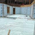 Right – Two inches of rigid foam was installed on the ground before pouring the basement floor slab while precast, pre-insulated concrete panels comprise the basement walls.