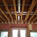 Right – Fiberglass batt insulation fills the walls while the floor joists above are insulated with spray foam insulation to both insulate and air seal this transition space.