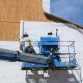Right – House wrap is safely installed using a boom lift. 