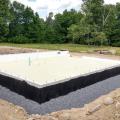 Right – The foundation of this ICF home was constructed of ICFs that were set in place on a gravel bed, then 3.5 inches (R-36) of closed-cell spray foam was sprayed directly onto the gravel, providing an effective air, vapor, and thermal barrier.
