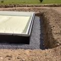 Right – A dimpled plastic rainscreen product is installed over liquid-applied waterproofing on the exterior of the ICF foundation walls, directing water down the wall to the perimeter drain tile, thus encouraging drainage around the foundation.