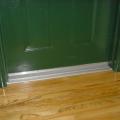 Doors to individual units in a multifamily building are separated from corridors using weatherstripping and airtight door sweeps.