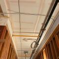 The ceiling and sides of this service corridor in a multifamily building are air-sealed with mudded and taped drywall prior to installing pipes, wiring, and ducts.