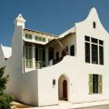 White walls and roofs; overhangs and awnings; and operable shutters and garden walls all help to keep out unwanted solar heat gain providing cool interiors for this Florida home.