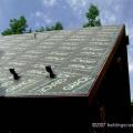 Self-adhering bituminous membrane covers the entire roof of this cold climate home, a practice common under metal roofs and also on complicated roofs 
