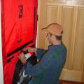 Contractors use a blower door to measure overall house air leakage.