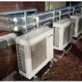 This fully specified central heat pump water heating system has four individual outdoor heat pump units plumbed in parallel to indoor storage tanks 