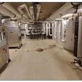 This mechanical room contains both the storage tanks (right) and heat pumps (left) of a central heat pump water heating system