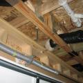 In cold climates, plumbing pipes should not be located in the building cavities over the garage