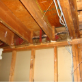 Wrong - When ceiling joists over a garage run perpendicular to the adjoining wall, the joist bays must be blocked and sealed to prevent garage fumes from entering the living space