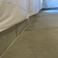Caulk the seam between the slab and foundation wall