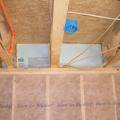 Insert rigid blocking pieces into each joist bay and fasten with caulk or nails