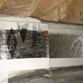Right - This unvented crawlspace is insulated along the walls and between the floor joists with 2-inch foil-faced polyisocyanurate; a termite inspection gap is visible above of the wall insulation and below the band joist.