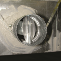 Right - The butterfly damper of this crawlspace supply register opens when the HVAC fan is running; the damper duct is sealed with mastic and supported by strapping. 