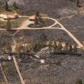 Defensible space and ignition resistant building materials saved this home from a wildland fire that destroyed the neighboring home in the foreground 