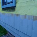 Drainage behind wood shingle cladding is provided by a 3/8-inch-thick drainage mat.