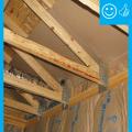 Right - Continuous wall sheathing and blocking has been installed to brace the raised heel trusses.